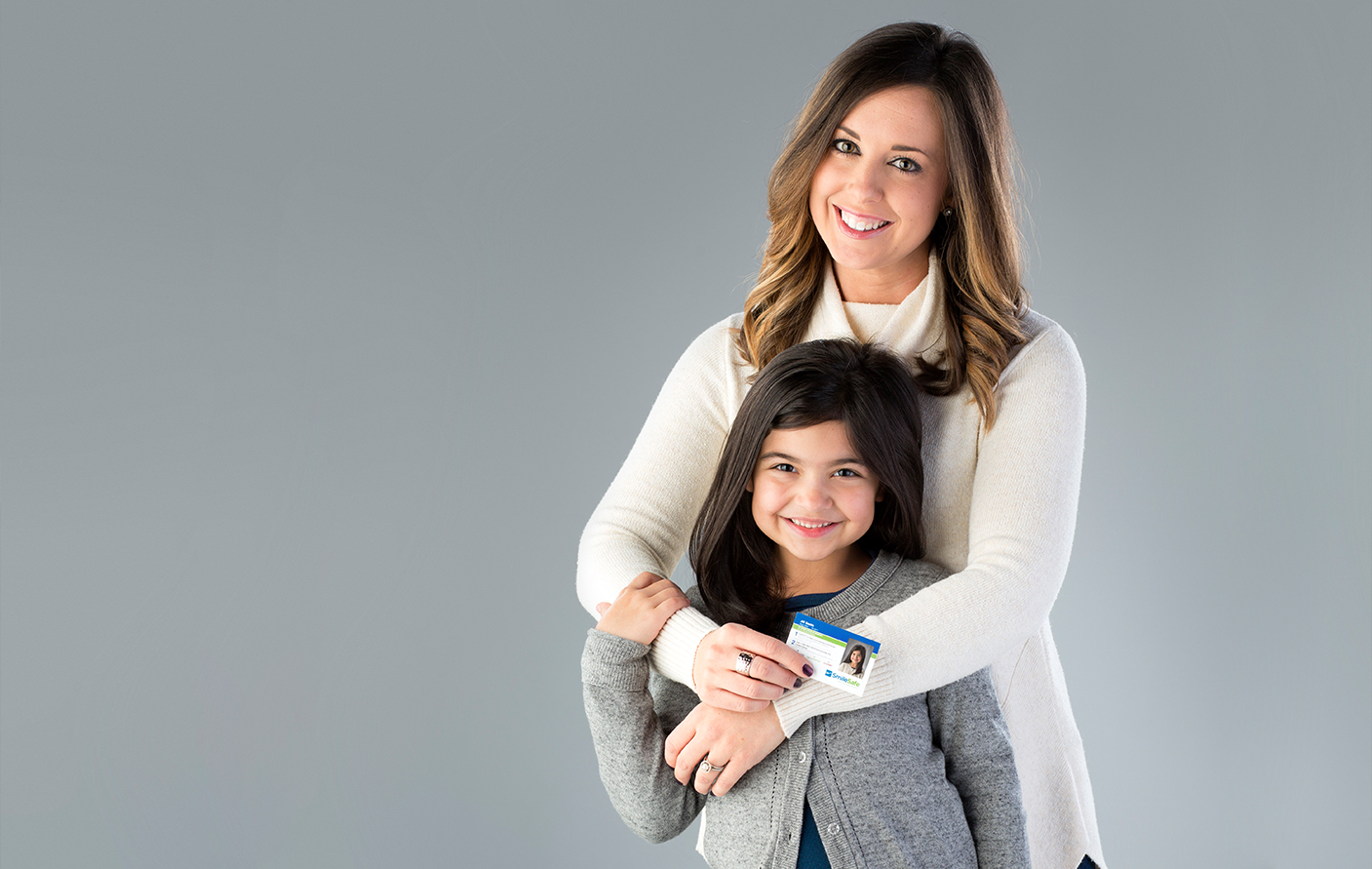 Lifetouch Smile Safe Program Mom With Daughter Holding Id Card