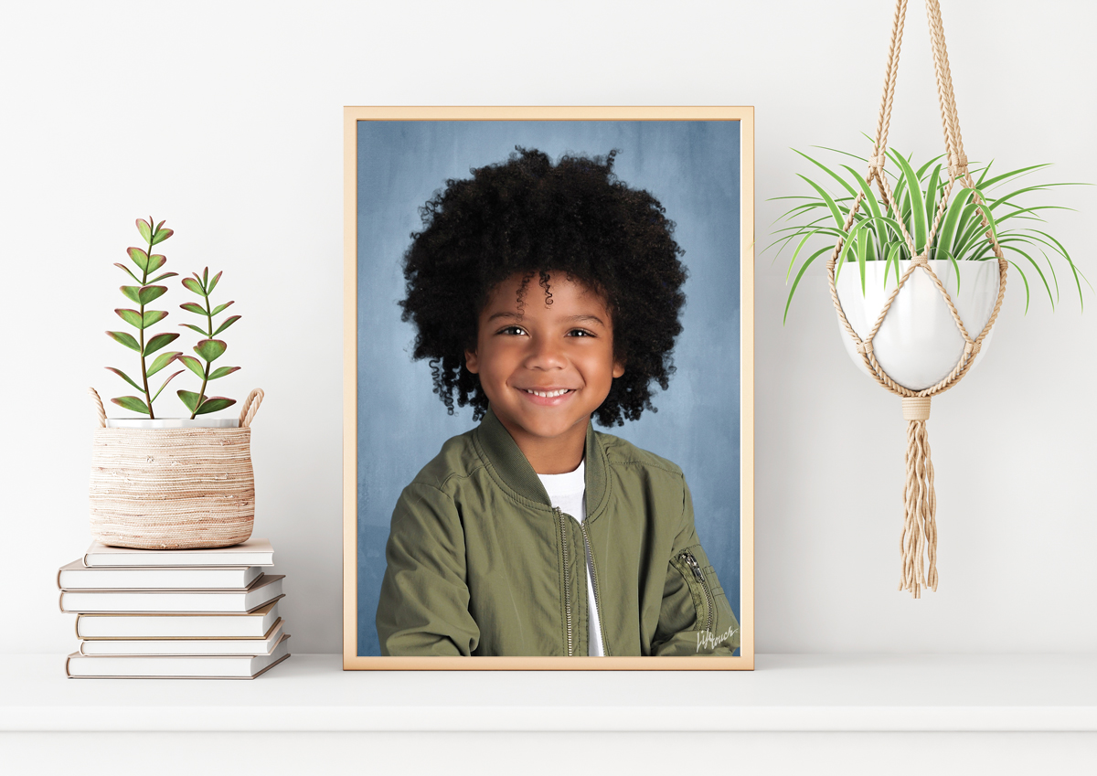 White frame sitting on a desk with child's school photo inside frame.