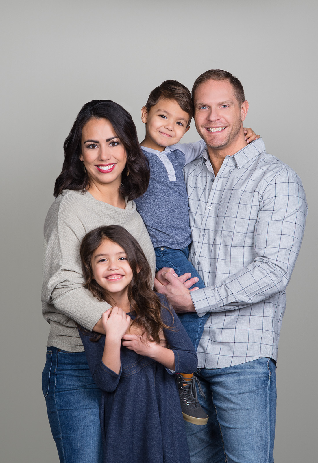 family of four on gray photography background.