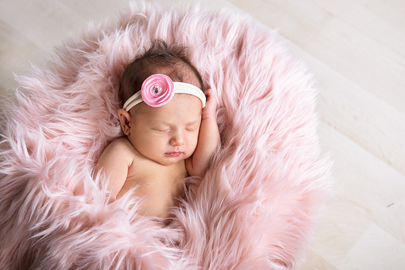 newborn baby girl with pink headband