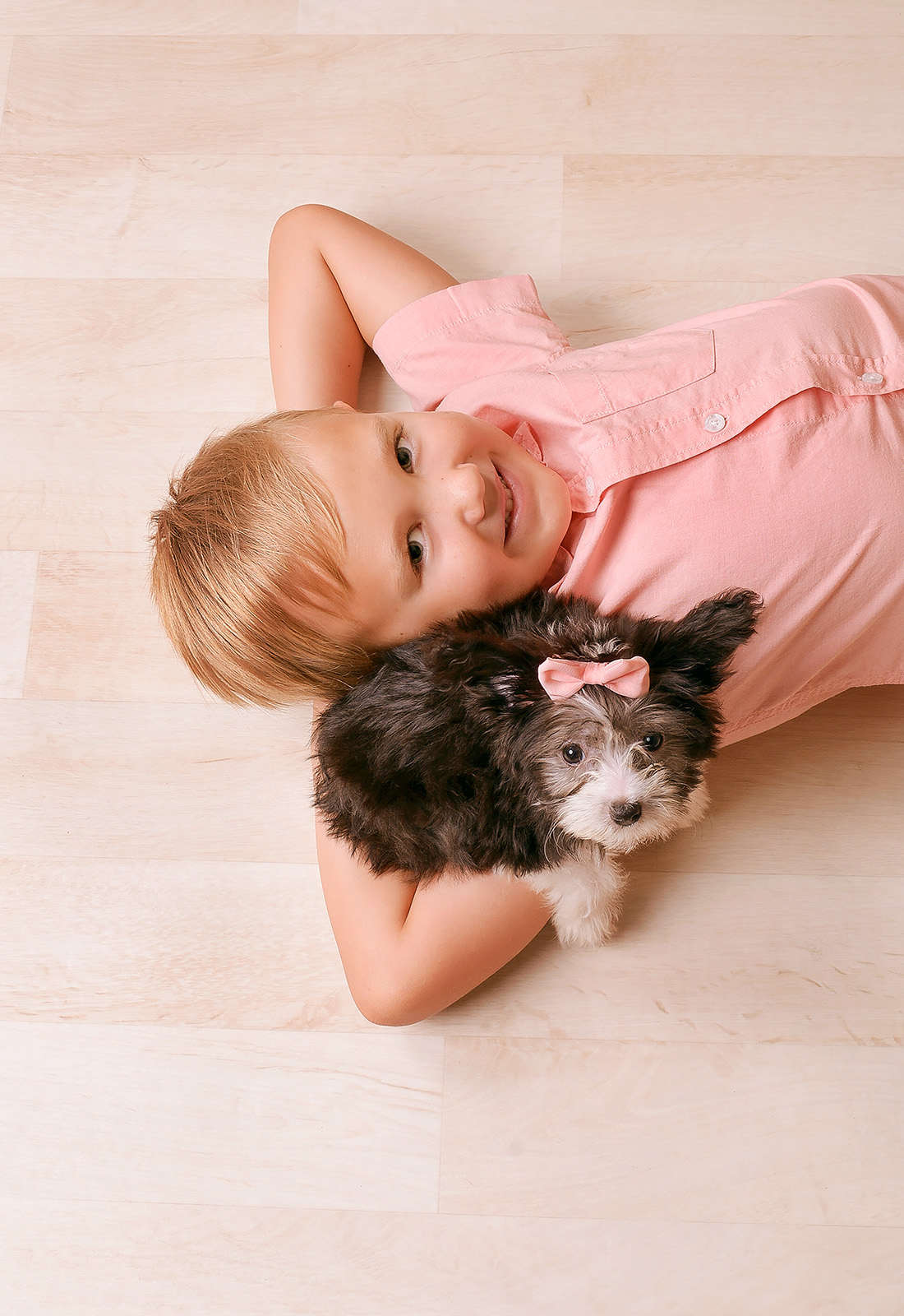 boy in pink shirt with dog