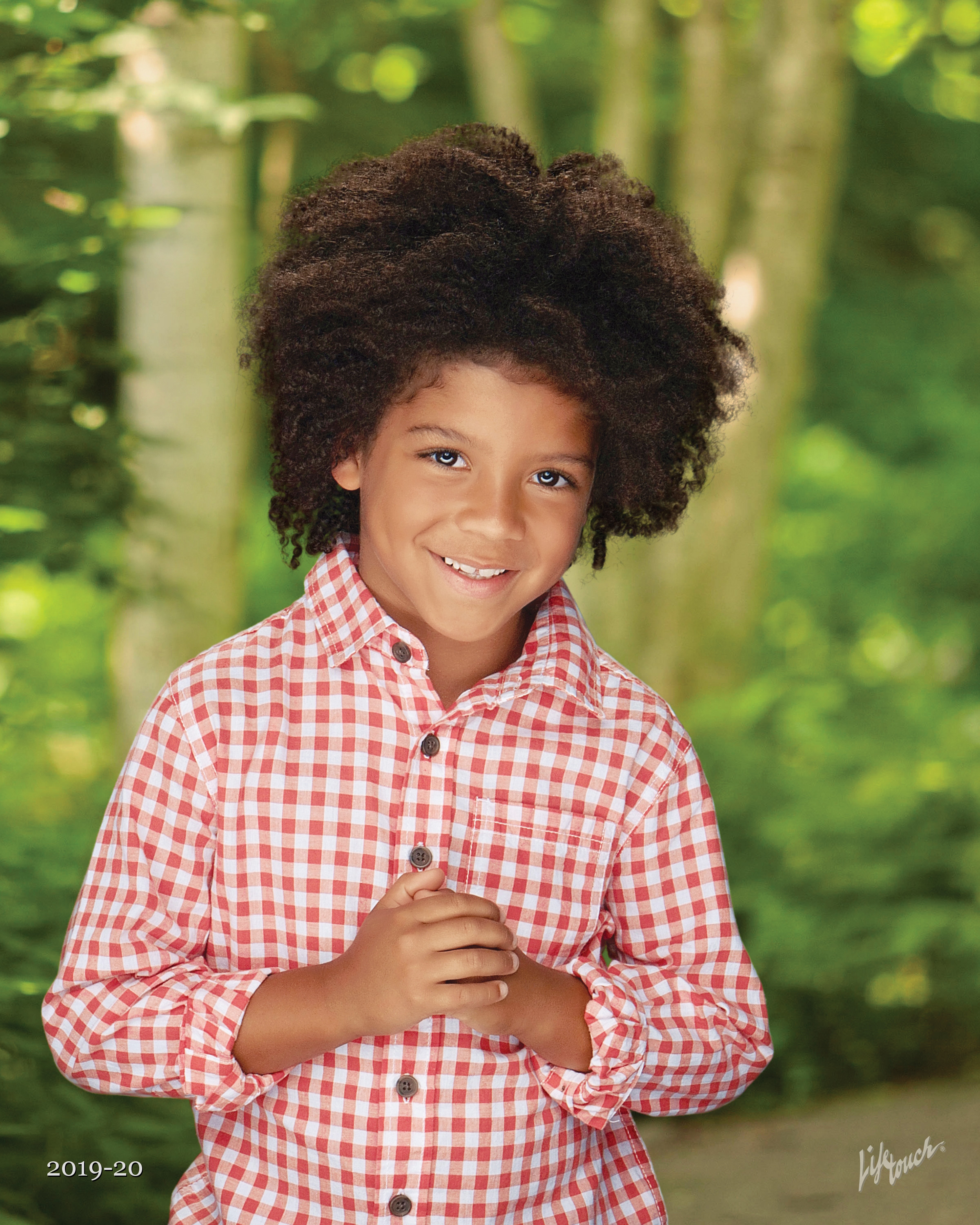 boy in checkered shirt on spring photography background